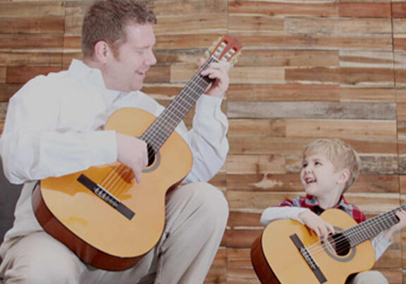 Eric Nehring and his son, Caleb Nehring playing guitar at Minnesota School of Music
